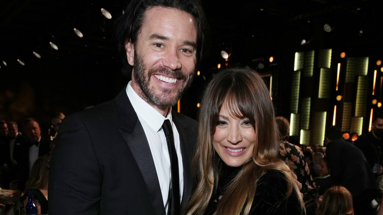 Tom Pelphrey and Kaley Cuoco smiling.
