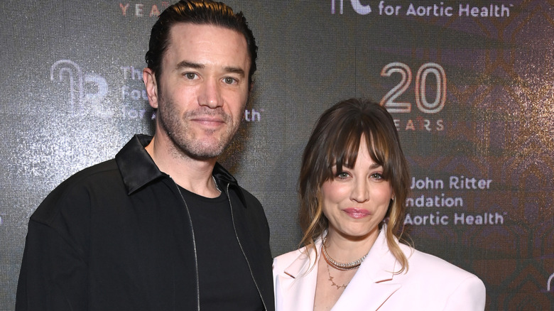 Tom Pelphrey and Kaley Cuoco posing.
