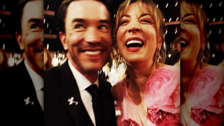 Tom Pelphrey and Kaley Cuoco laughing in burry image