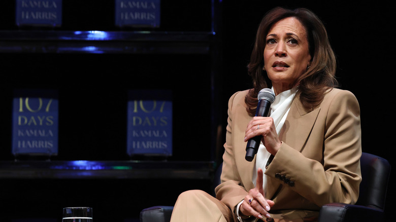 Kamala Harris speaking into microphone