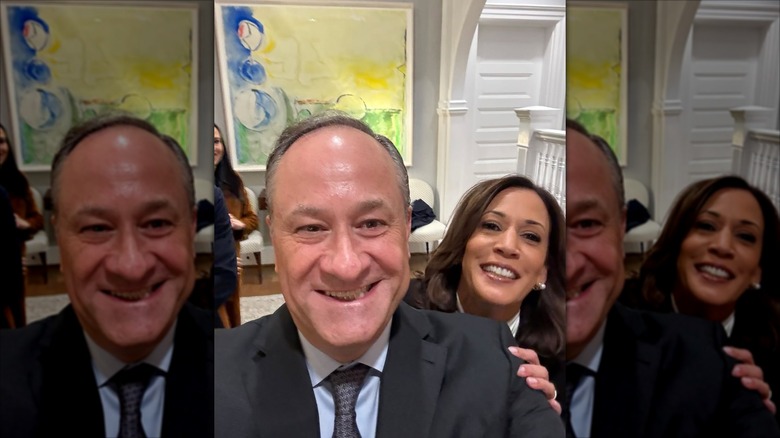 Doug Emhoff taking a self with Kamala Harris behind him