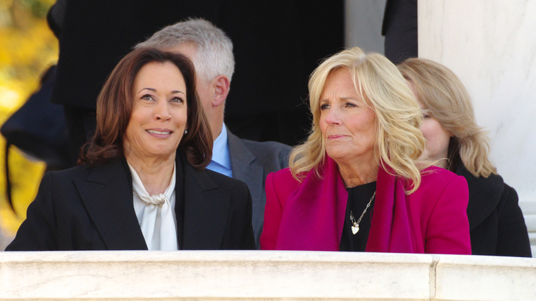 Jill Biden and Kamala Harris smiling while sitting next to each other