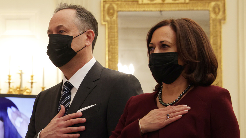 Douglas Emhoff and Kamala Harris with hands on hearts