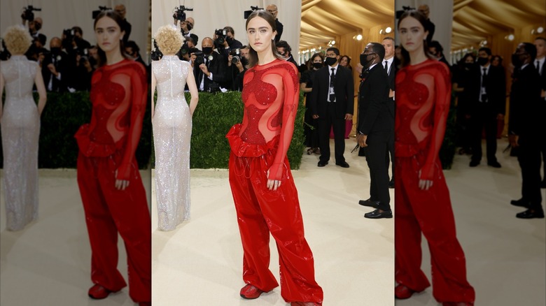 Ella Emhoff posing on the Met Gala red carpet in a red cut out top and bagy pants