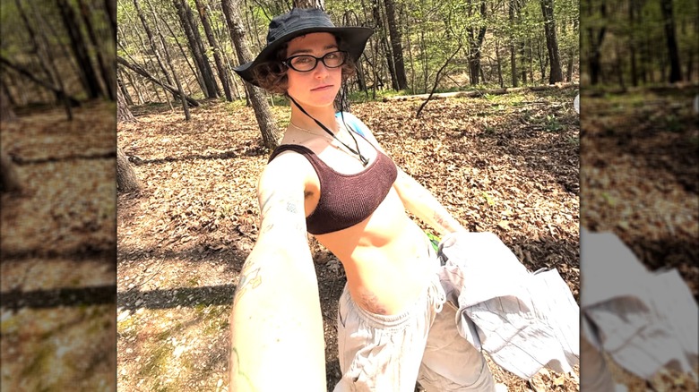 Selfie of Ella Emhoff wearing a body baring outfit while walking in the woods