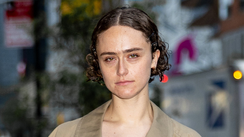 Ella Emhoff with center parted short curly hairposing for the camera in New York