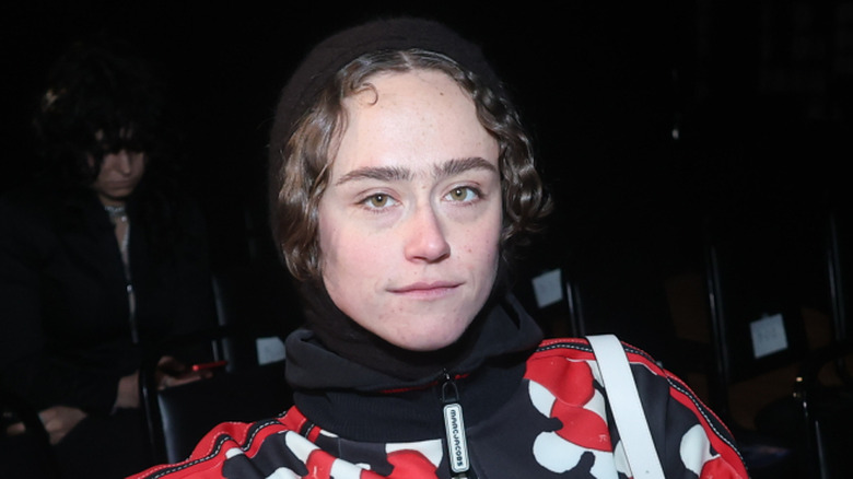 Ella Emhoff sitting down wearing a red carpet while attending the Tyler McGillivary fashion show.