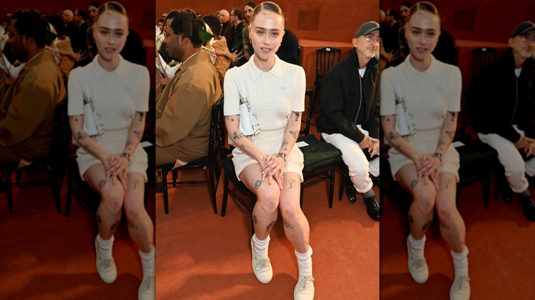 Ella Emhoff sitting with hands on lap in an all white outfit