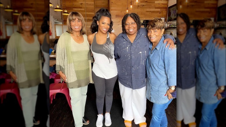 Kandi Burruss and Todd Tucker posing with Aunt Bertha and Mama Joyce at Christmas party