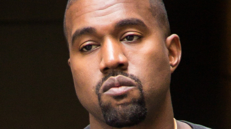 Kanye West wears a baggy sweatshirt.