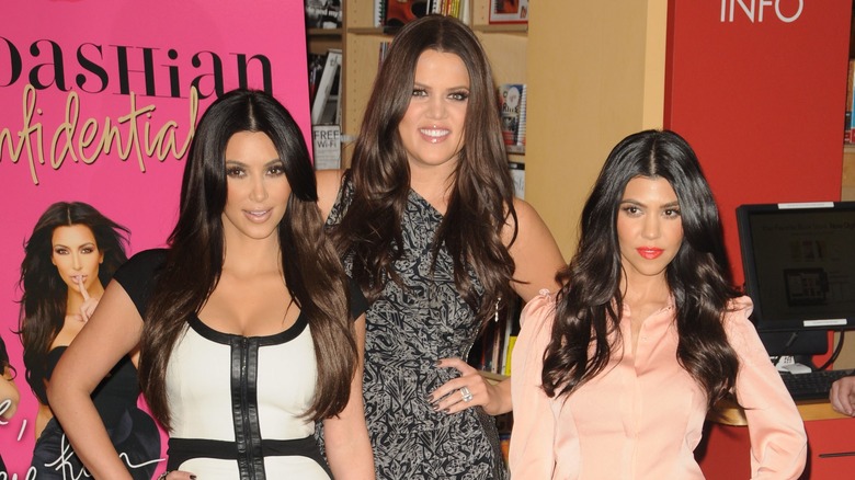 Khloe, Kourtney, and Kim Kardashian posing