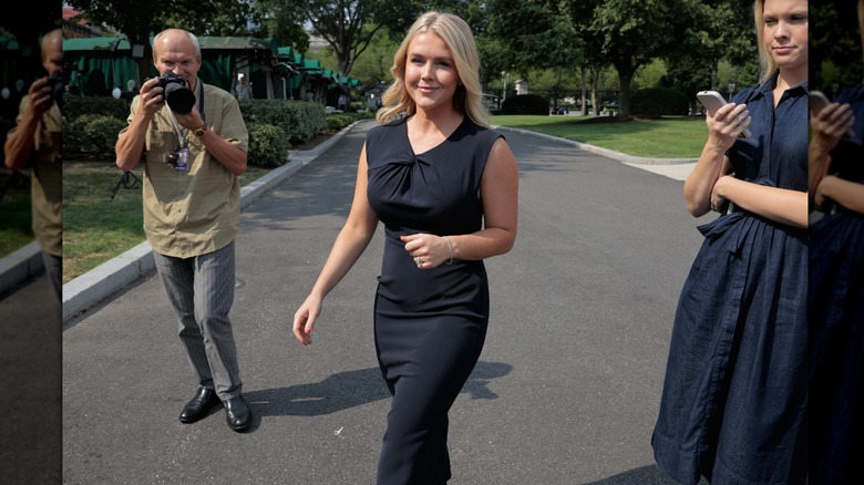 Karoline Leavitt walks in a black dress