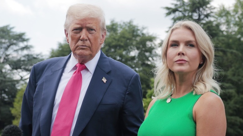 Donald Trump and Karoline Leavitt speak to the media outside the White House in Washington, DC (2025)