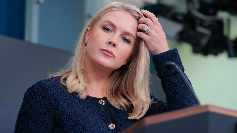 Karoline Leavitt scowling in a navy topp