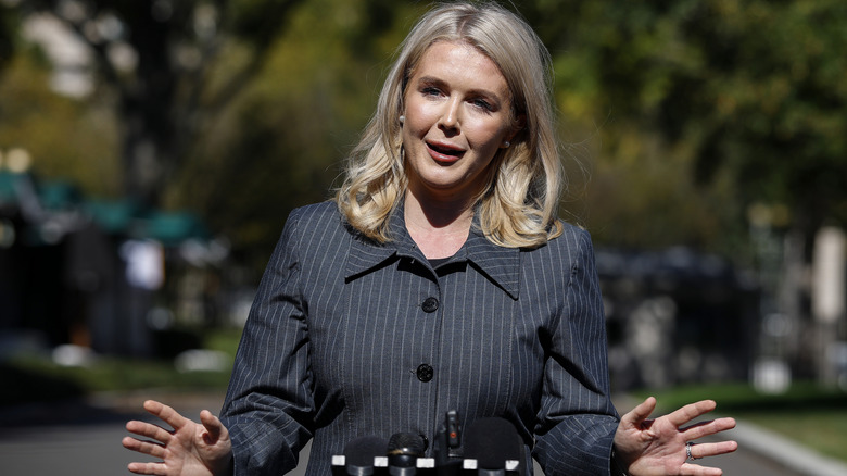 Karoline Leavitt wearing a black pinstriped shirt