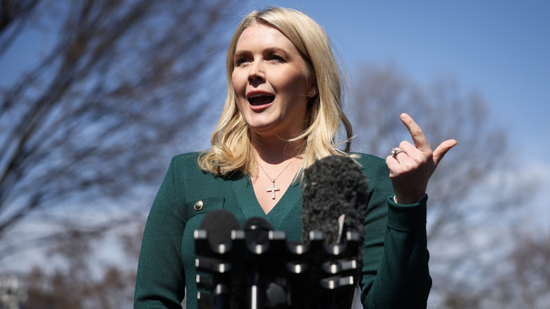 Karoline Leavitt speaks into microphones
