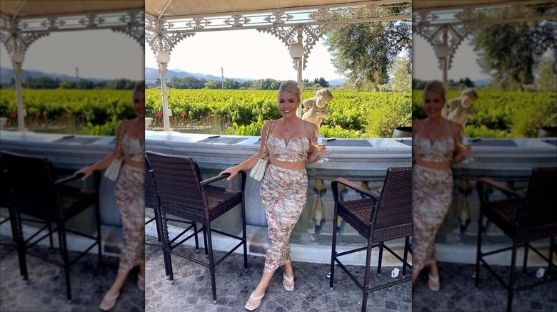 Karoline Leavitt holds a glass of wine