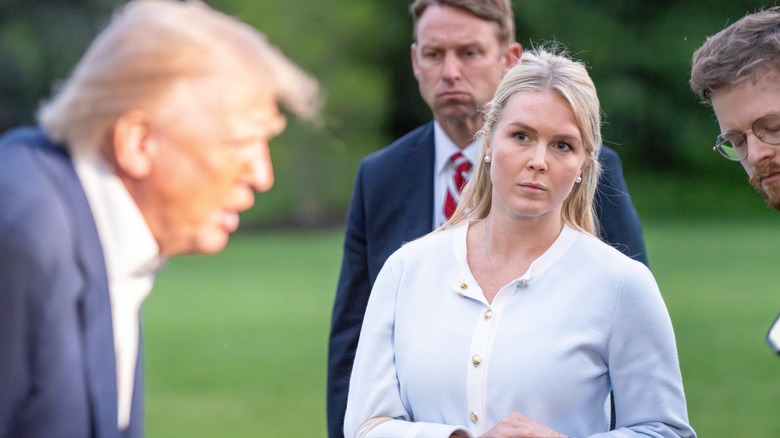 Karoline Leavitt staring eerily at Donald Trump