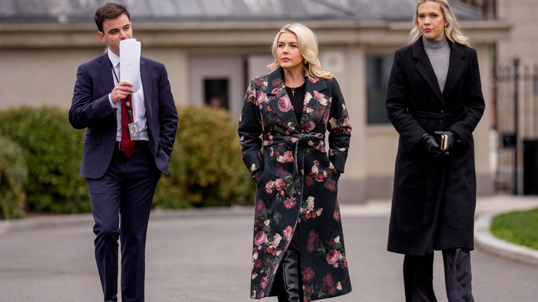 Karoline Leavitt walking black coat with pink flowers