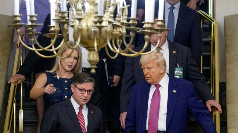 Karoline Leavitt and Donald Trump walk downstairs together