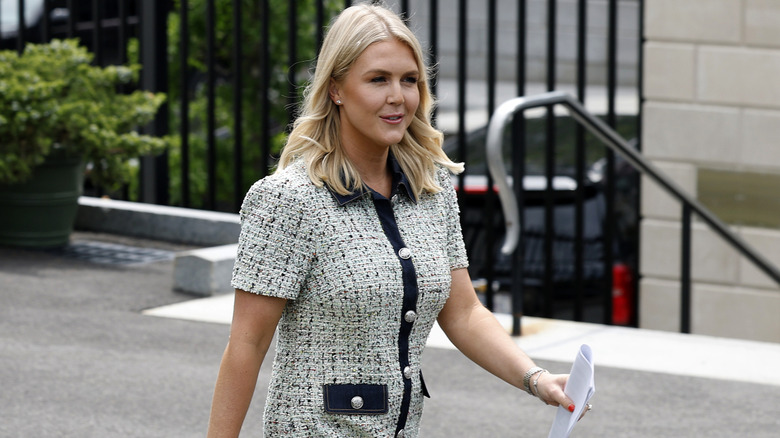 Karoline Leavitt walking outside of the White House.