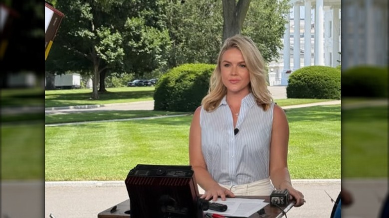 Karoline Leavitt at a podium waiting to deliver remarks in Washington, DC (2025)