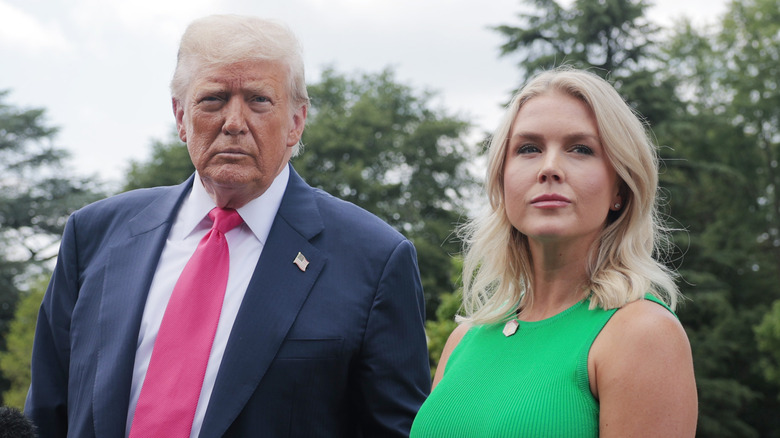 Donald Trump and Karoline Leavitt giving a press briefing in Washington DC