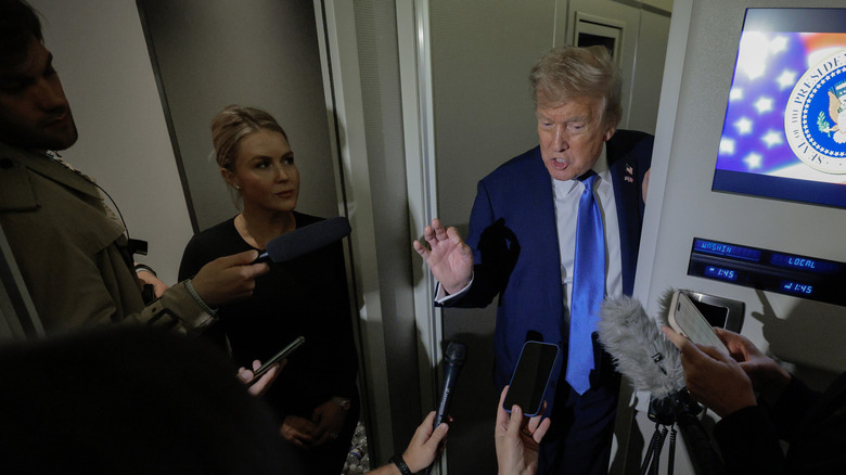 Karoline Leavitt and Donald Trump speaking to press
