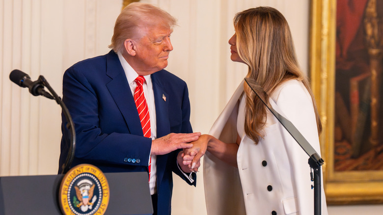 Donald Trump holding Melania hand at podium