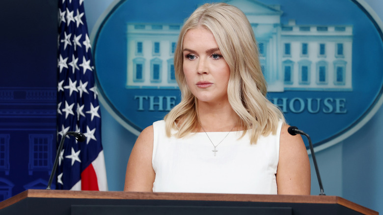 Karoline Leavitt scowling at podium
