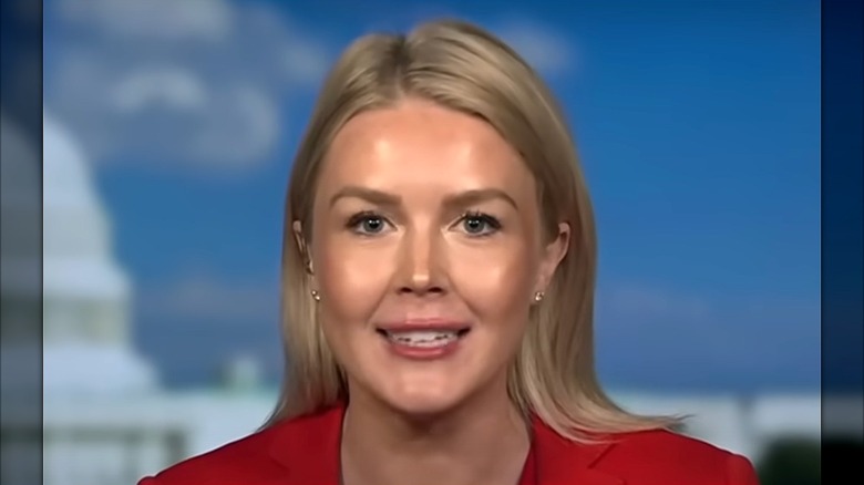 Karoline Leavitt red suit shiny face