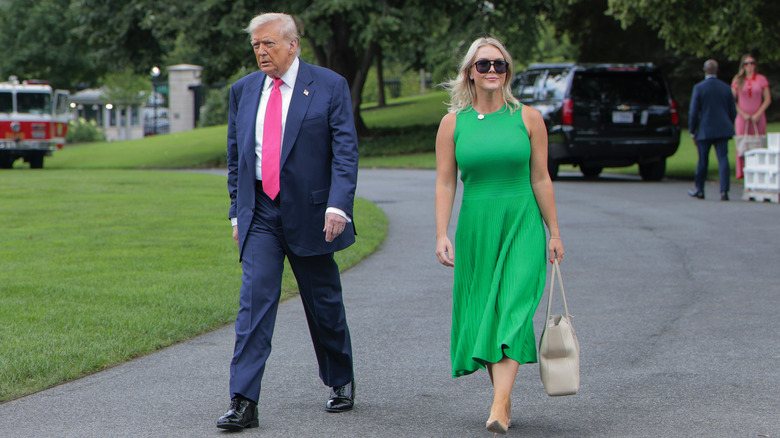 Karoline Leavitt smiling and walking with Donald Trump