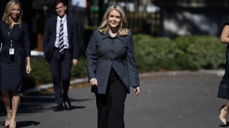 Karoline Leavitt walks towards reporters outside the White House (2025)