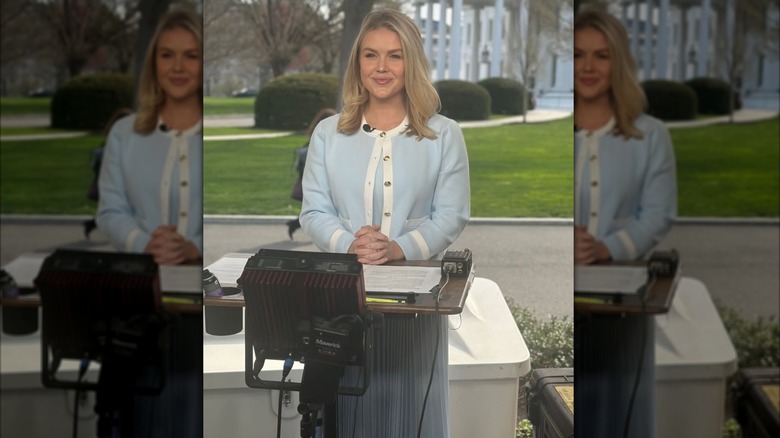 Karoline Leavitt at podium in blue skirt and top