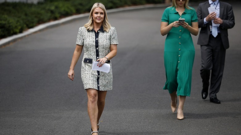 Karoline Leavitt walks towards reporters outside the White House