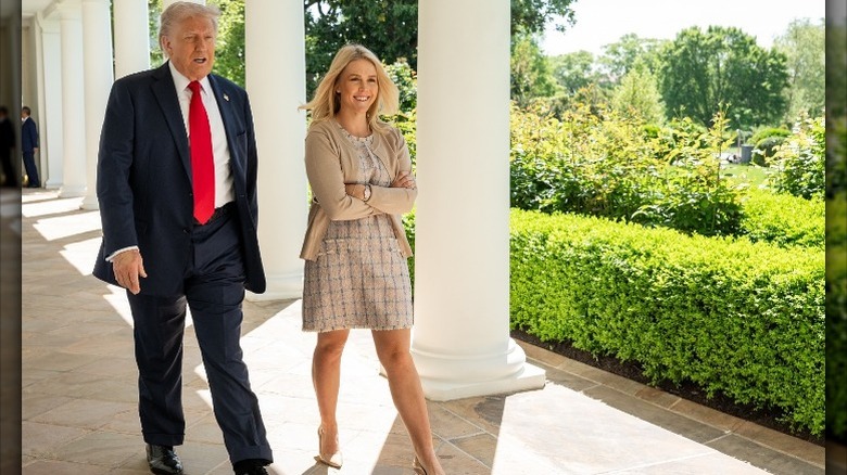 Donald Trump and Karoline Leavitt walking outside the White House