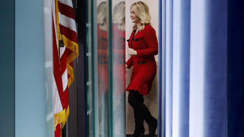 Karoline Leavitt in short red dress with tall black boots