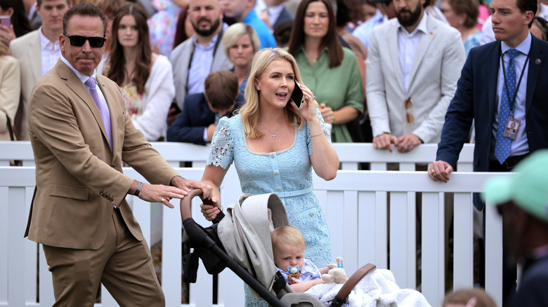 Nicholas Riccio and Karoline Leavitt pushing baby in a stroller