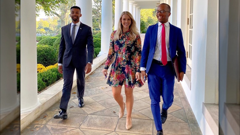 Karoline Leavitt smiling and walking