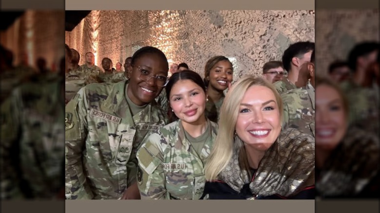 Karoline Leavitt posing with military members