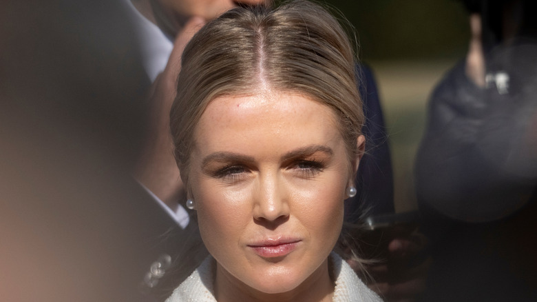 Karoline Leavitt smiling with her hair pulled back in a center parting