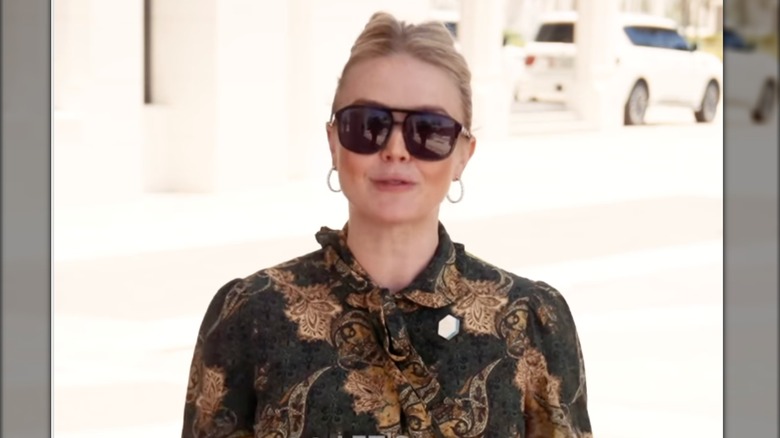 Karoline Leavitt wearing a granny shirt and brown sunglasses