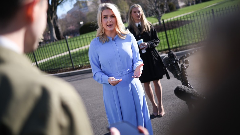 Karoline Leavitt, facing a crowd, taken among the press.