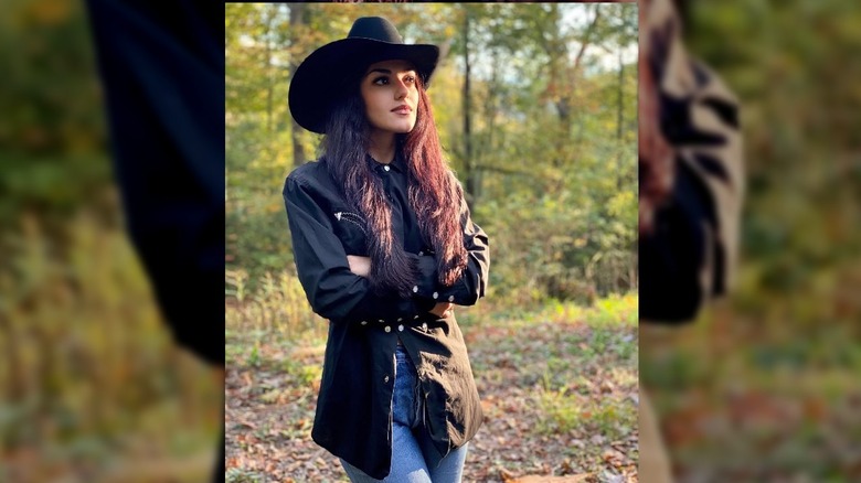 Alexis Wilkins standing in a field.