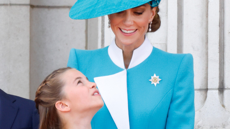 Princess Charlotte looking up lovingly at her mother Kate Middleton at Trooping the Colour 2025