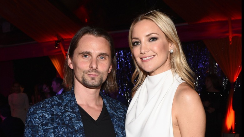 Matt Bellamy and Kate Hudson smiling while posing together at an event in 2014