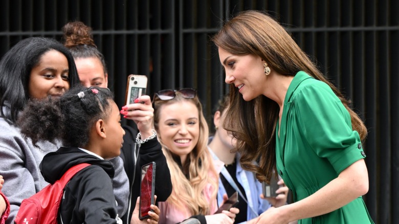 Kate Middleton talking with a child