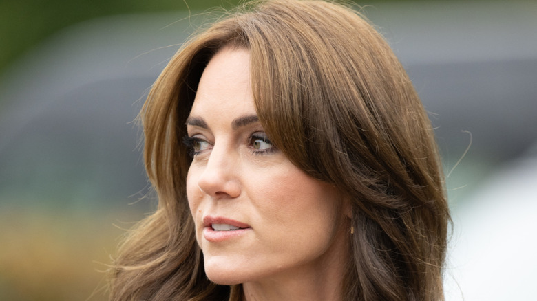 Kate Middleton looking over her shoulder at a mental fitness workshop run by SportsAid at Bisham Abbey National Sports Centre (2023)