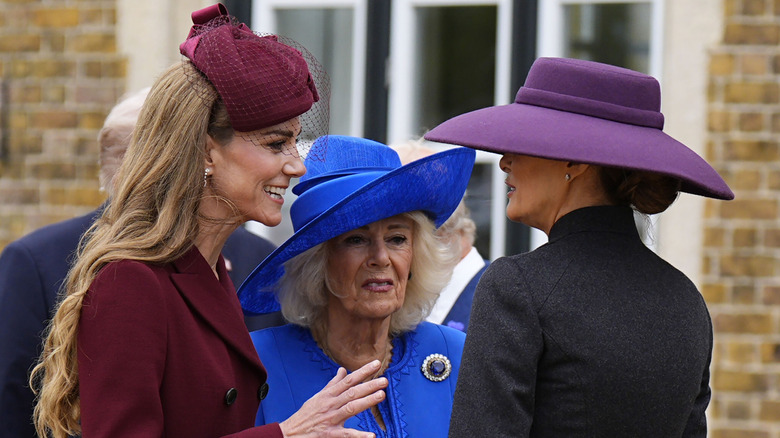 Catherine, Princess of Wales speaking to Melania Trump as Queen Camilla listens