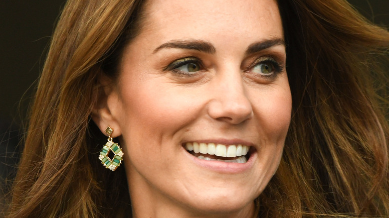 Kate Middleton smiles at an event.